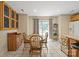 Open dining area with a wood table, large windows, and tile flooring throughout at 14340 Kendalton Meadow Dr, Mint Hill, NC 28227