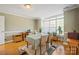 Bright dining room featuring hardwood floors, a table, and a large window at 14340 Kendalton Meadow Dr, Mint Hill, NC 28227
