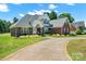 Charming brick house featuring a well-manicured lawn and a spacious driveway at 14340 Kendalton Meadow Dr, Mint Hill, NC 28227