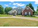 Charming brick two-story home with manicured landscaping and a curved driveway at 14340 Kendalton Meadow Dr, Mint Hill, NC 28227