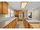Bright kitchen with wood cabinets, a center island with bar seating and white appliances at 14340 Kendalton Meadow Dr, Mint Hill, NC 28227