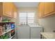 Compact laundry room with cabinets above the washer and dryer at 14340 Kendalton Meadow Dr, Mint Hill, NC 28227
