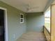 The covered back porch features wood flooring, green siding, ceiling fan, and natural lighting at 149 Mason Tanner Ct, Rock Hill, SC 29730