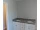 Modern bathroom features double sinks with granite countertop and white cabinets at 149 Mason Tanner Ct, Rock Hill, SC 29730