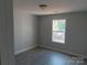 Bedroom featuring natural lighting, gray walls, white trim, and wood look flooring at 149 Mason Tanner Ct, Rock Hill, SC 29730