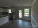 View of the kitchen and dining area, featuring white cabinets, wood look floors, and natural light at 149 Mason Tanner Ct, Rock Hill, SC 29730