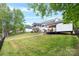 Wide backyard with a patio, covered deck, lake view, an outdoor structure, and lush green grass at 184 Quiet Cove Rd, Mooresville, NC 28117