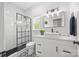 Modern bathroom with subway tile shower, patterned tile floor, and white vanity with vessel sink at 184 Quiet Cove Rd, Mooresville, NC 28117