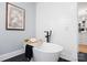 A freestanding tub with black hardware, a shiplap wall, and tile flooring at 184 Quiet Cove Rd, Mooresville, NC 28117