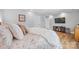 Comfortable bedroom featuring soft bedding, hardwood floors, and a built-in TV at 184 Quiet Cove Rd, Mooresville, NC 28117