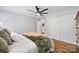 Serene bedroom features plush bedding, hardwood floors, closet doors, and soft, neutral tones at 184 Quiet Cove Rd, Mooresville, NC 28117