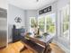 Cozy breakfast nook with wood table, bench seating, and natural light from large windows at 184 Quiet Cove Rd, Mooresville, NC 28117