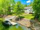 Lakeside home featuring a dock, boat, spacious yard, screened porch, and outdoor structure at 184 Quiet Cove Rd, Mooresville, NC 28117