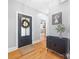 Bright foyer with hardwood floors, front door with glass, and console table at 184 Quiet Cove Rd, Mooresville, NC 28117