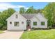 Charming white farmhouse-style home featuring a well-manicured lawn and black-framed windows at 184 Quiet Cove Rd, Mooresville, NC 28117