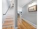 Hallway showcasing beautiful hardwood floors leading to staircase and main living area at 184 Quiet Cove Rd, Mooresville, NC 28117