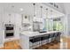 Modern kitchen with white cabinets, marble countertops, and a large central island at 184 Quiet Cove Rd, Mooresville, NC 28117