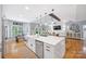 Open-concept kitchen with white cabinets, island, and views into the living area at 184 Quiet Cove Rd, Mooresville, NC 28117