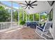 Inviting screened porch with comfortable blue seating, ceiling fan, and views of the surrounding landscape at 184 Quiet Cove Rd, Mooresville, NC 28117