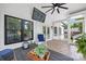 Relaxing screened porch with outdoor furniture, ceiling fan, TV, and backyard views at 184 Quiet Cove Rd, Mooresville, NC 28117
