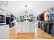 Expansive walk-in closet with custom storage solutions and hardwood floors at 184 Quiet Cove Rd, Mooresville, NC 28117