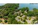 Beautiful aerial view of lakefront homes nestled among lush trees with private docks on a sunny day at 19523 Sunnypoint Ct, Cornelius, NC 28031