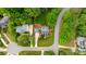 Aerial view of a charming home with a manicured lawn and mature landscaping, surrounded by lush green trees at 19523 Sunnypoint Ct, Cornelius, NC 28031