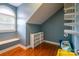 Finished attic space with hardwood floors, a bench, and plenty of storage shelving at 19523 Sunnypoint Ct, Cornelius, NC 28031