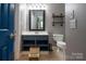 Bathroom featuring a gray color scheme, blue vanity and decorative shelves at 19523 Sunnypoint Ct, Cornelius, NC 28031