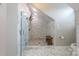 Bathroom featuring a marble tiled walk-in shower with built-in bench at 19523 Sunnypoint Ct, Cornelius, NC 28031