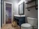 Stylish bathroom featuring a navy vanity with open shelves, modern fixtures, and a step stool at 19523 Sunnypoint Ct, Cornelius, NC 28031