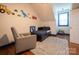 Inviting bedroom with whimsical dinosaur wall art, daybed, and ample natural light, creating a cheerful atmosphere at 19523 Sunnypoint Ct, Cornelius, NC 28031