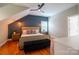 Vaulted bedroom featuring wood floors, a bench, natural light, and blue accent wall at 19523 Sunnypoint Ct, Cornelius, NC 28031