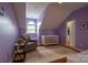 Charming Bedroom featuring soft lilac walls, a cozy chair, and a white crib, perfect for a peaceful haven at 19523 Sunnypoint Ct, Cornelius, NC 28031