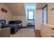 A cute bedroom with a reading corner, bed, dresser, hardwood floors and plenty of natural light at 19523 Sunnypoint Ct, Cornelius, NC 28031