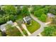 Aerial view of a charming home with a manicured lawn and mature landscaping, surrounded by lush green trees at 19523 Sunnypoint Ct, Cornelius, NC 28031