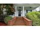Traditional home with a welcoming front porch and manicured landscaping at 19523 Sunnypoint Ct, Cornelius, NC 28031