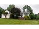 Charming two-story traditional style home with well-manicured lawn and manicured landscaping at 19523 Sunnypoint Ct, Cornelius, NC 28031