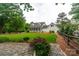 Spacious front yard with manicured lawn and a charming white home with inviting porch at 19523 Sunnypoint Ct, Cornelius, NC 28031