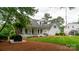 Beautiful white home with a welcoming front porch, a perfect spot for relaxation at 19523 Sunnypoint Ct, Cornelius, NC 28031