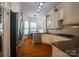 Modern kitchen featuring granite countertops, stainless steel appliances, and ample cabinet space at 19523 Sunnypoint Ct, Cornelius, NC 28031