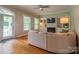Comfortable living room with a fireplace, built-in shelving, and plenty of natural light at 19523 Sunnypoint Ct, Cornelius, NC 28031