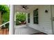 Inviting front porch with swing, ceiling fan, and plenty of light at 19523 Sunnypoint Ct, Cornelius, NC 28031