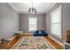 Bright room with hardwood floors, large windows, and neutral walls, perfect for a playroom at 19523 Sunnypoint Ct, Cornelius, NC 28031