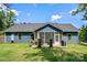 View of the screened porch and spacious backyard with a well-maintained lawn and a patio with a dining table set at 1994 Hollybrook Ln # 17, Lancaster, SC 29720
