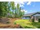 Spacious backyard with a lush green lawn, a wooded backdrop, and a cozy patio, perfect for outdoor enjoyment at 1994 Hollybrook Ln # 17, Lancaster, SC 29720
