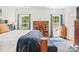 Comfortable bedroom features natural light, wood furnishings and a blue striped rug at 1994 Hollybrook Ln # 17, Lancaster, SC 29720