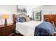 Charming bedroom features a wood bed frame, bedside lamps, and a bright window at 1994 Hollybrook Ln # 17, Lancaster, SC 29720