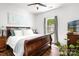 Cozy bedroom with a dark wood bed frame, wood floors, neutral paint, and great natural light at 1994 Hollybrook Ln # 17, Lancaster, SC 29720