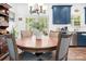 Bright dining area featuring a round wooden table, stylish chairs, and abundant natural light from large windows at 1994 Hollybrook Ln # 17, Lancaster, SC 29720